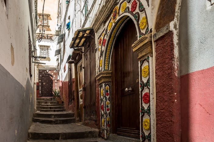 Steep stepped lane in the Casbah of Algiers with a painted carved doorway