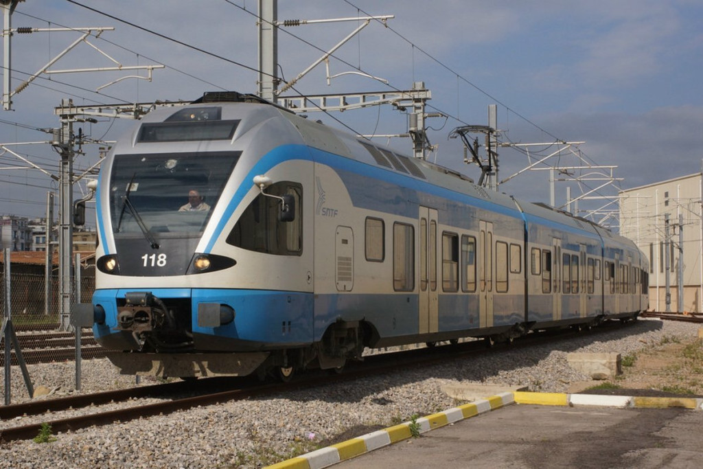 Blue and white SNTF electric commuter train at a station in Algeria