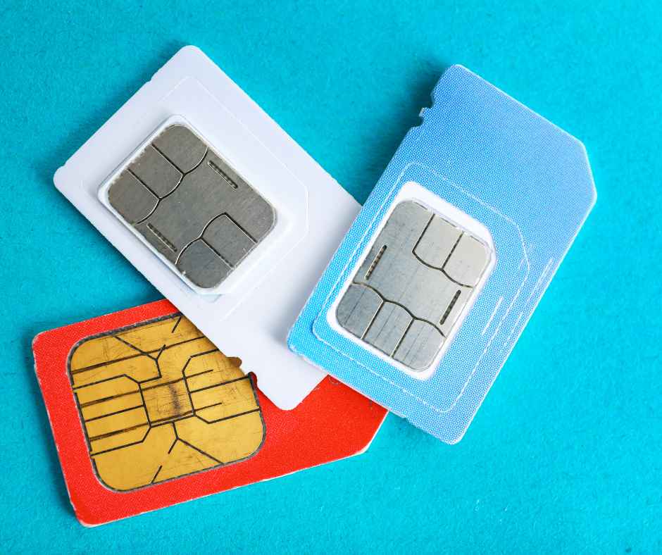 Three SIM cards in different colors on a turquoise background