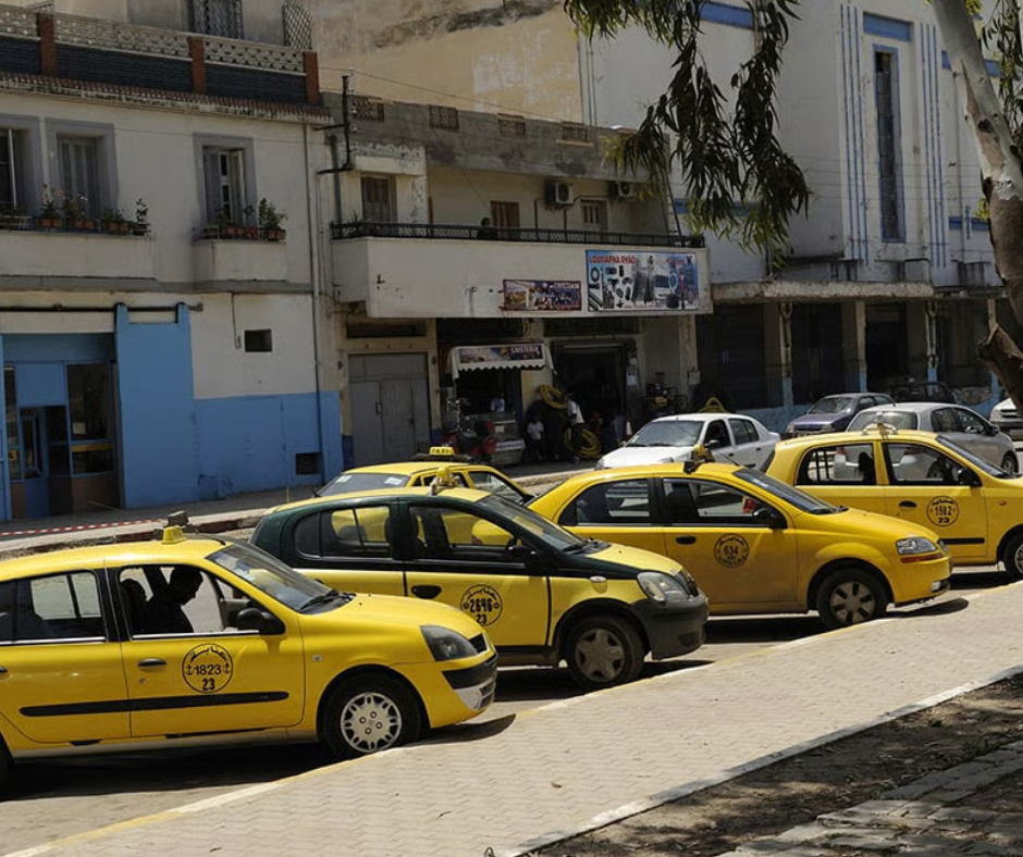 Yellow taxis parked along a street in Algiers