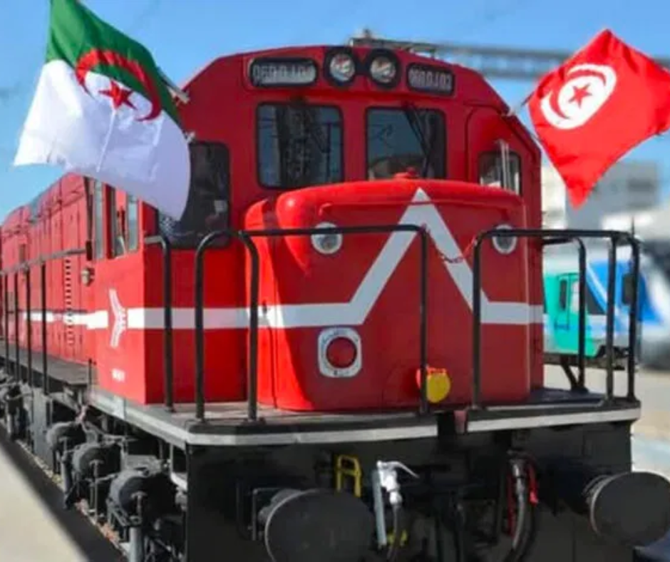 Red diesel locomotive decorated with Algerian and Tunisian flags