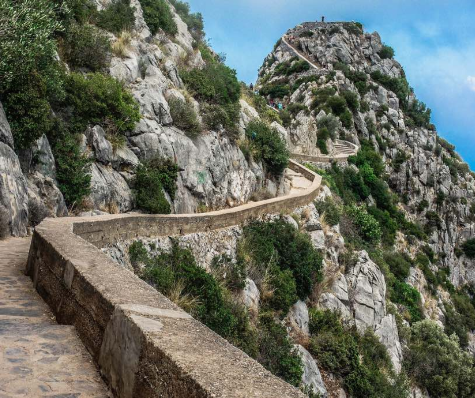Stone-walled path climbing the rocky slope of Gouraya National Park in Bejaia