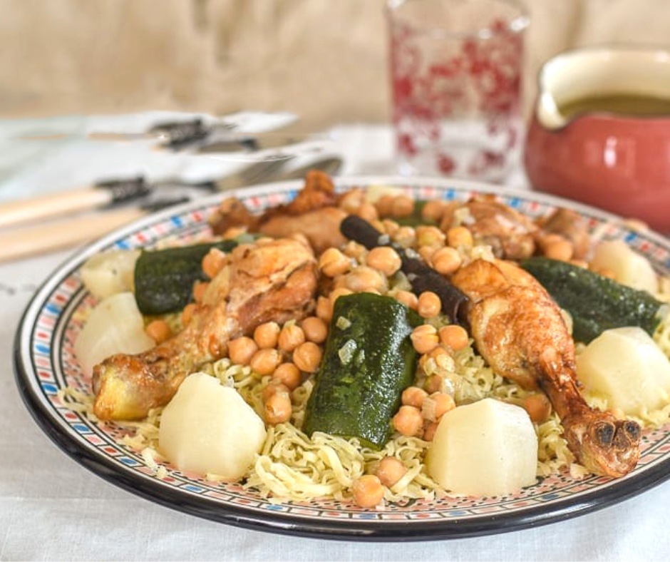 Plate of rechta noodles with chicken, chickpeas, zucchini and turnips