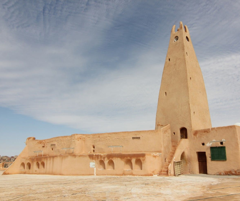 Tapering sand-colored minaret and mosque walls in a M'Zab valley town
