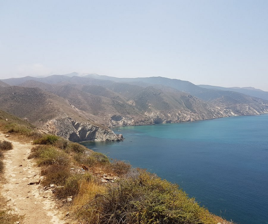 Footpath along dry cliffs above the blue sea at Cap de l'Aiguille